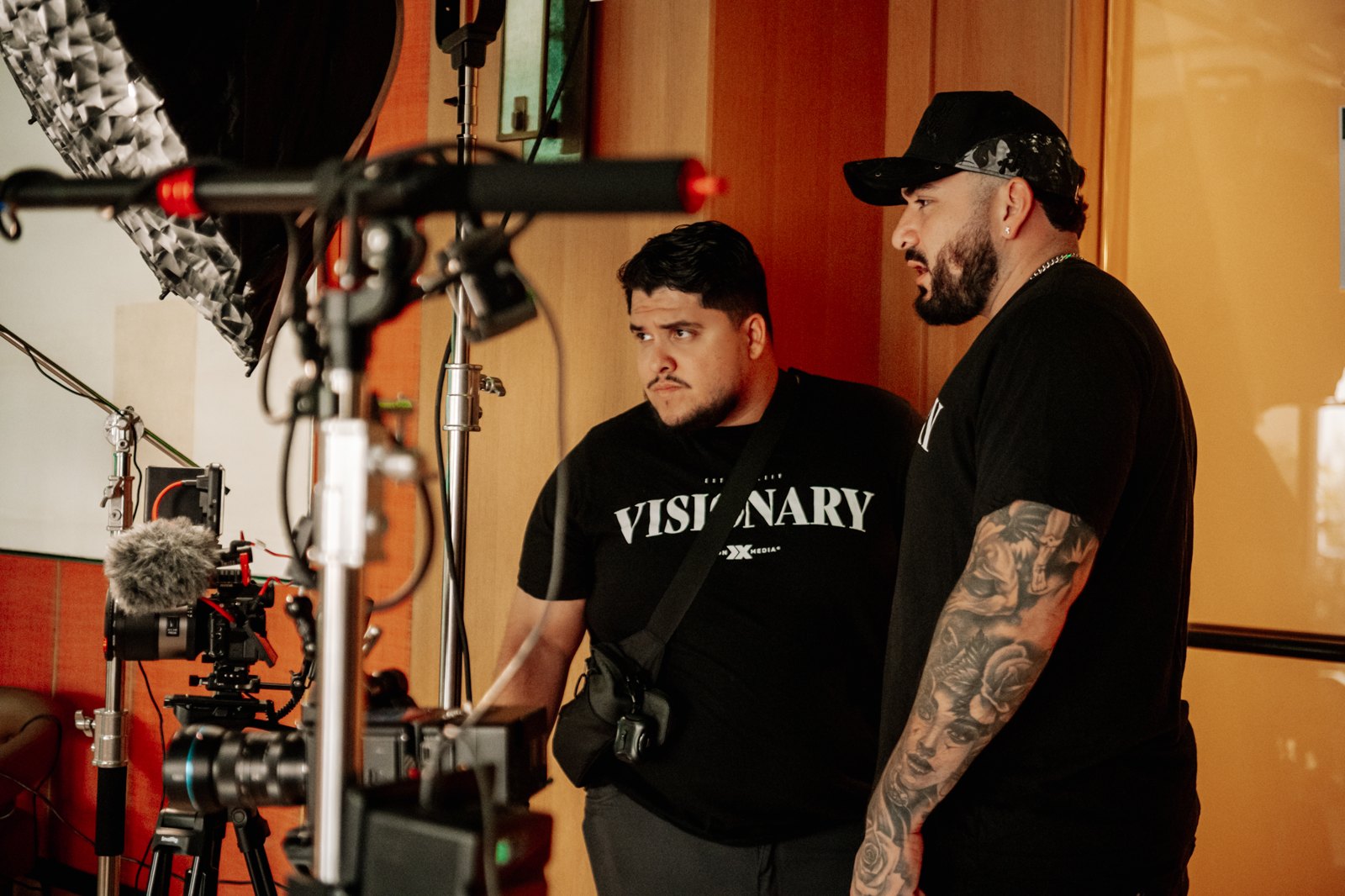 Two Visionx crew members reviewing a camera and lighting setup