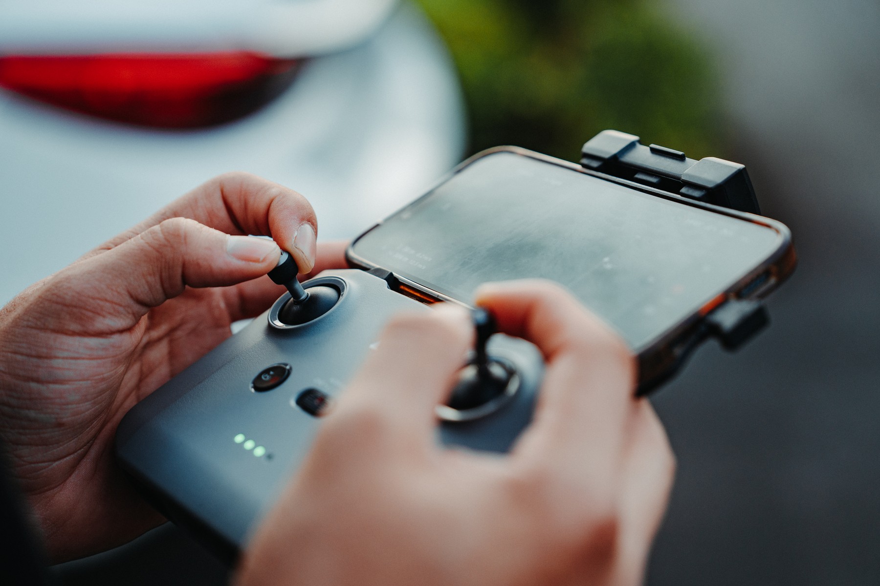 Close view of a crew member using a drone controller outdoors