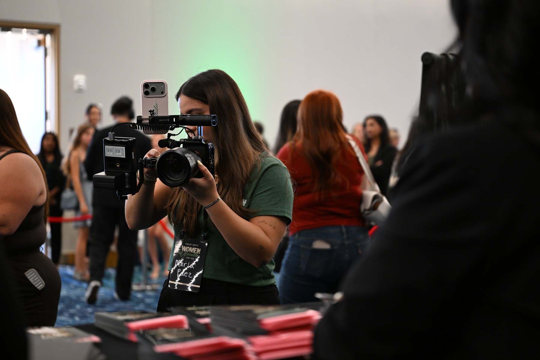 A Visionx camera operator filming with a cinema camera at an event booth